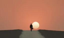 a man walking into the sunset