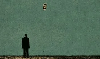 a man staring at a flying dollar bill