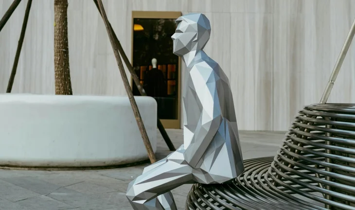 Statue of businessman on bench