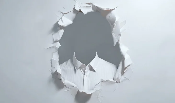 a tear in some paper revealing a shirt but no face or head