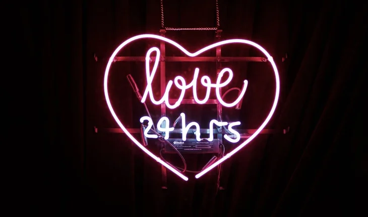 a sign that says love 24 hours