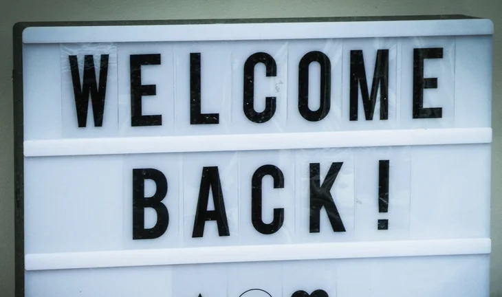 a sign that says welcome back