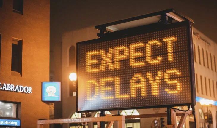 A sign that says Expect delays 