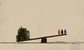 a seesaw with some little people and a pile of metal junk