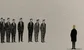 some junior bankers looking at a man with a golden head 